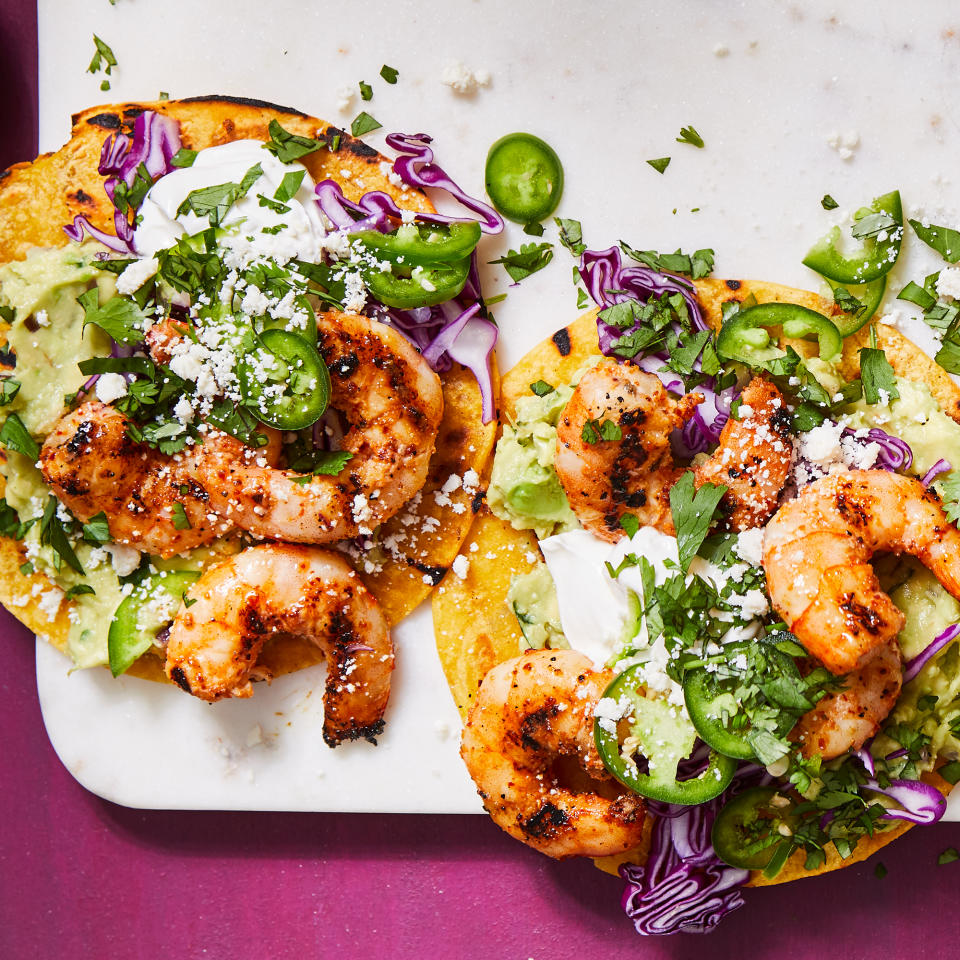 <p>Grilling gives these shrimp tostadas a boost of smoky flavor. Skewering the shrimp prevents them from falling through the grates while getting even char on each side. If you have a grill basket, you can throw them in that instead; just make sure to get them into a single layer so they don't steam. <a href="https://www.eatingwell.com/recipe/7896397/grilled-shrimp-tostadas/" rel="nofollow noopener" target="_blank" data-ylk="slk:View Recipe;elm:context_link;itc:0;sec:content-canvas" class="link ">View Recipe</a></p>