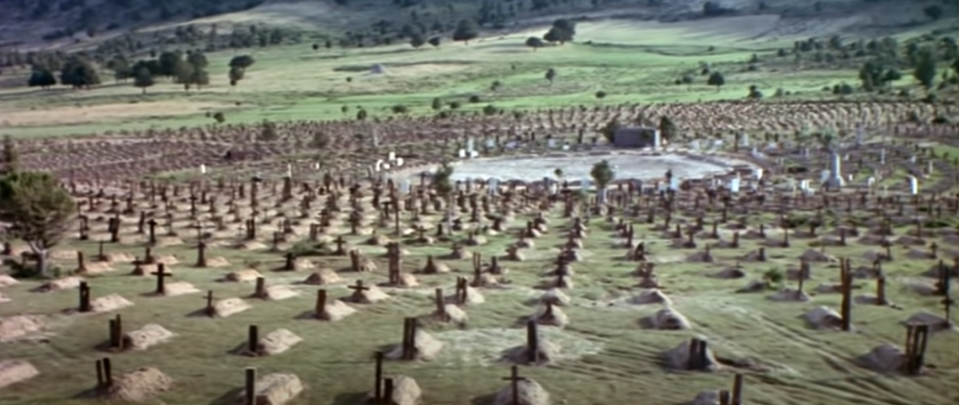 A man runs through a graveyard