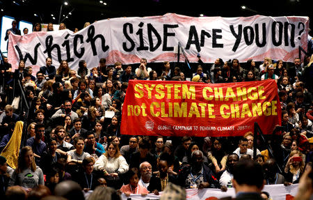 People attend a Global Campaign to Demand Climate Justice demonstration before the final session of the COP24 U.N. Climate Change Conference 2018 in Katowice, Poland, December 14, 2018. REUTERS/Kacper Pempel