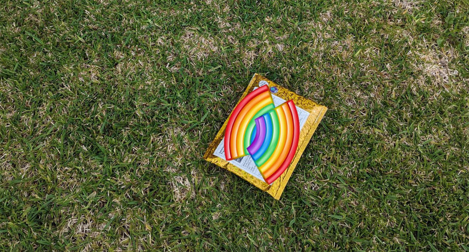 A small yellow parcel lies on the grass.