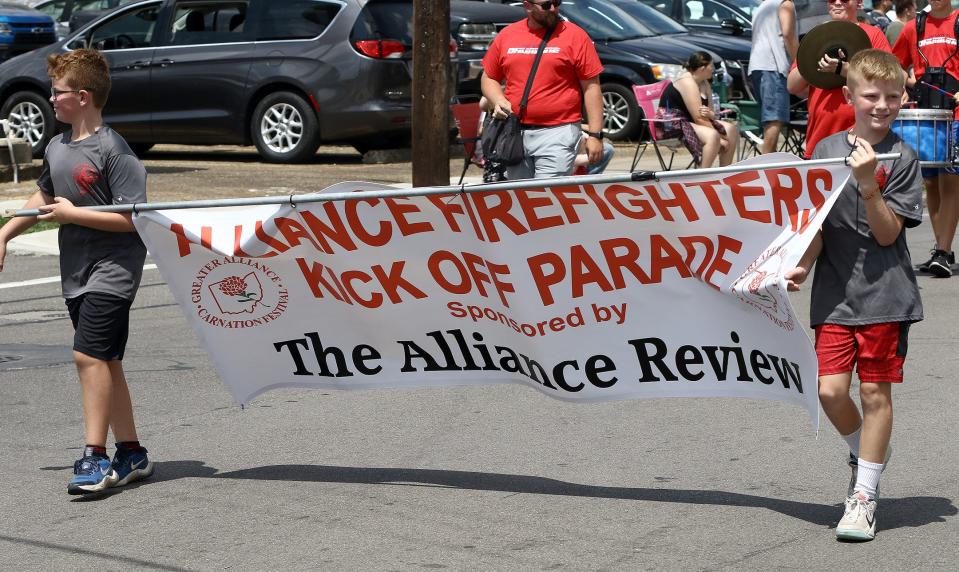 Two young boys carried the banners that announced the start of the Greater Alliance Carnation Festival Kick Off Parade, as it headed south Sunday, Aug. 7, 2022, on Union Avenue.