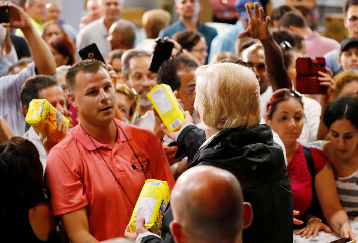 <p>President Donald Trump hands out bags of rice to a crowd of local residents affected by Hurricane Maria as he visits a disaster relief distribution center at Calgary Chapel in San Juan, Puerto Rico, Oct. 3, 2017. (Photo: Jonathan Ernst/Reuters) </p>