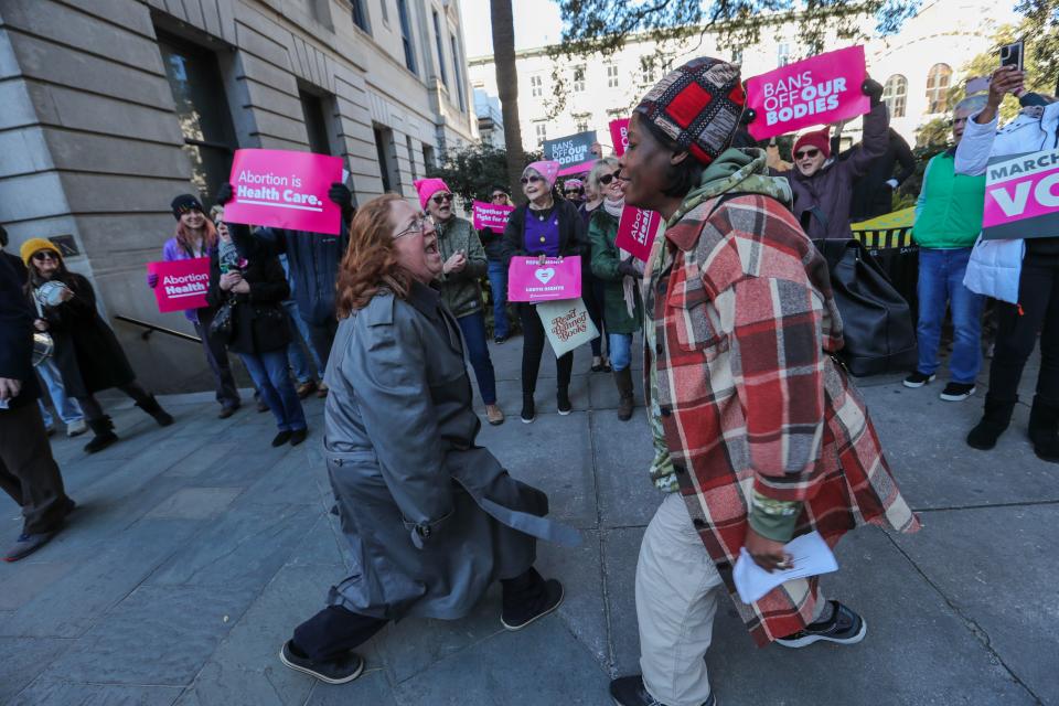 Genevieve Hawkins and Tenee Baker dance and lead a chant together during the "Bigger Than Roe" rally and march on Saturday, January 20, 2024.