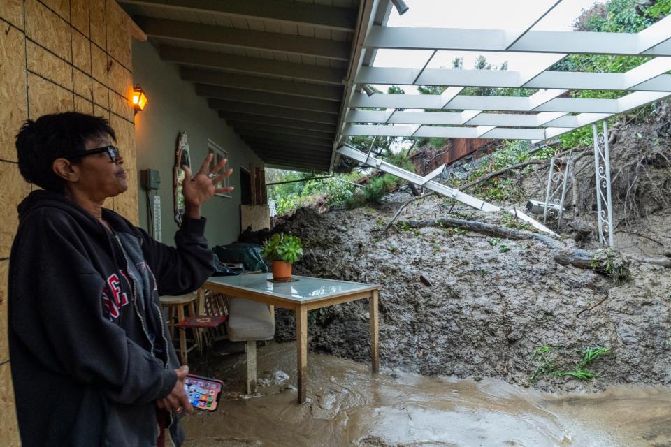 Home owner Dion Peronneau recounts how she was awoken by the sound of cracking around 4am on Monday morning as a mudflow forced its way into her home early in the Baldwin Hills area of Los Angeles (Copyright 2024 The Associated Press. All rights reserved)
