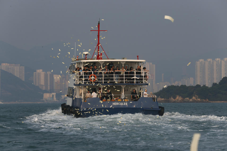 Relatives of victims who died in Monday's ferry collision throw paper money to pay tribute to those lost, Thursday, Oct. 4, 2012, in Hong Kong.  A show of concern by Beijing over the boat collision that killed dozens of people in Hong Kong this week has backfired, further damaging the communist government's image in the former British colony.  (AP Photo/Kin Cheung)