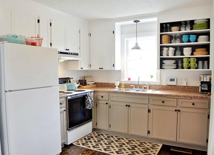 <body> <p>Voilà—painting the cabinets made them look brand-new. A few other details, such as spray-painted black hardware and a raised trim cleverly crafted from yardsticks, complete the look. The homeowners also achieved <a rel="nofollow noopener" href=" http://www.bobvila.com/open-shelves/33794-16-new-ways-to-store-kitchen-necessities/slideshows?bv=yahoo" target="_blank" data-ylk="slk:on-trend open shelving;elm:context_link;itc:0;sec:content-canvas" class="link ">on-trend open shelving</a> by simply removing cabinet doors and painting the inside of the cupboard a contrasting hue.</p> <p><strong>Related: <a rel="nofollow noopener" href=" http://www.bobvila.com/white-cabinets/2359-painted-cabinets-14-reasons-to-transform-yours-now/slideshows?bv=yahoo" target="_blank" data-ylk="slk:Painted Cabinets—14 Reasons to Paint Yours Now;elm:context_link;itc:0;sec:content-canvas" class="link ">Painted Cabinets—14 Reasons to Paint Yours Now</a> </strong> </p> </body>