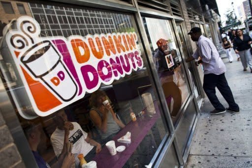 <h2>Dunkin' Donuts</h2><br><br>A customer enters a Dunkin' Donuts store in midtown Manhattan on July 11. Dunkin' Brands, the US fast-food chain which owns Dunkin' Donuts and Baskin-Robbins, saw its shares surge nearly 40 percent in value as they debuted on the Nasdaq stock exchange on Wednesday.