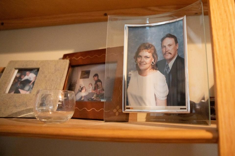 A photograph of Melissa’s mother and father sit on the shelf in Craig's living room.