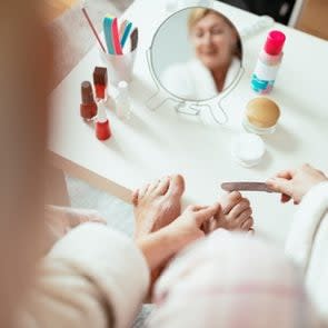 Mature woman having beauty treatment at home