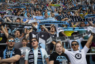 In this July 13, 2019, photo, Minnesota United fans chant and hold cup scarves in anticipation of the start of the MLS team's soccer match against FC Dallas in St. Paul, Minn. The first season for Minnesota United at Allianz Field has been a sold-out success. As the Loons prepare for their first MLS playoff game, they'll have their raucous supporters section behind them to help. (Alex Kormann./Star Tribune via AP)