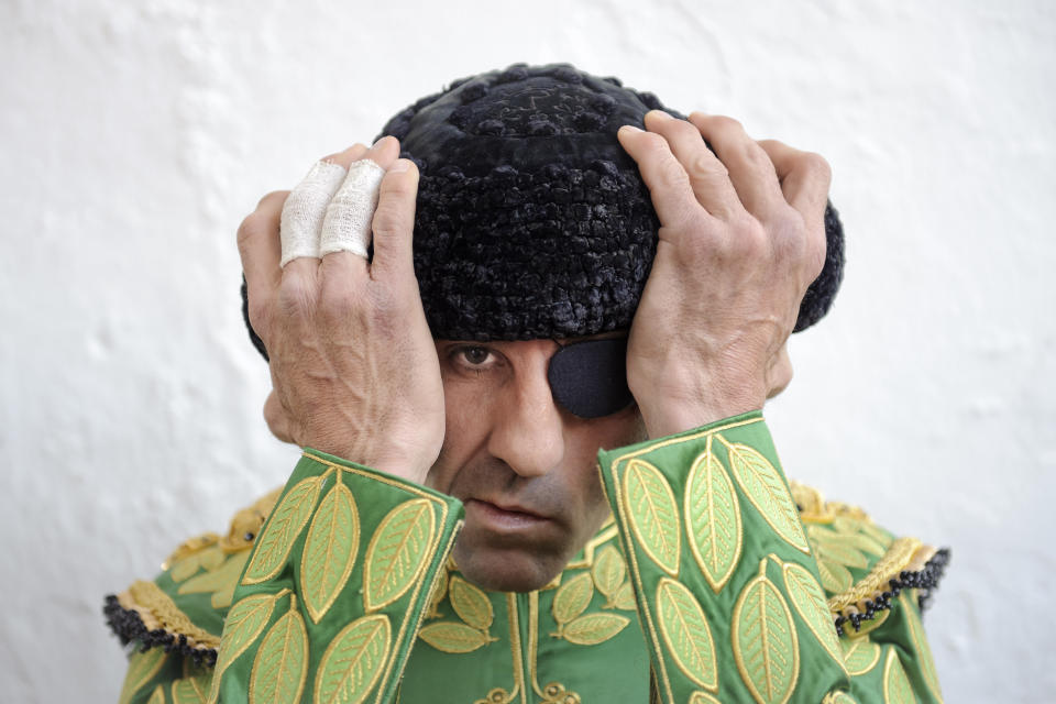 Spanish bullfighter Juan Jose Padilla adjusts his 'montera' or bullfighter hat, before a bullfight at the southwestern Spanish town of Olivenza, Sunday, March 4, 2012. Padilla, 38-year old matador who is also known by his professional name of 'the Cyclone of Jerez',  lost sight in one eye and has partial facial paralysis after a terrifying goring returned to the bullring Sunday, five months after his injury.(AP Photo/Daniel Ochoa de Olza)