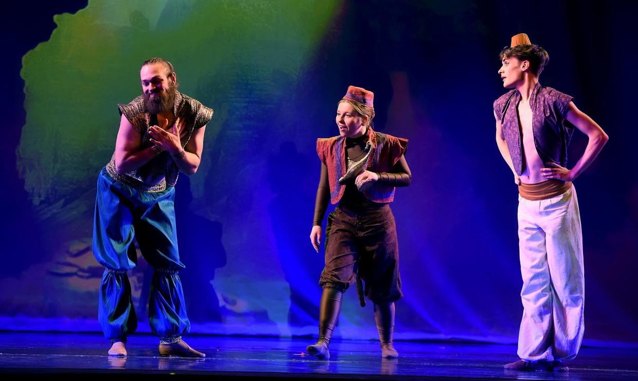 Matthew Pettrey as Genie entertains Rowan Westerlund as Abu and Nathan Glover as Aladdin in the cave scene of Aladdin.