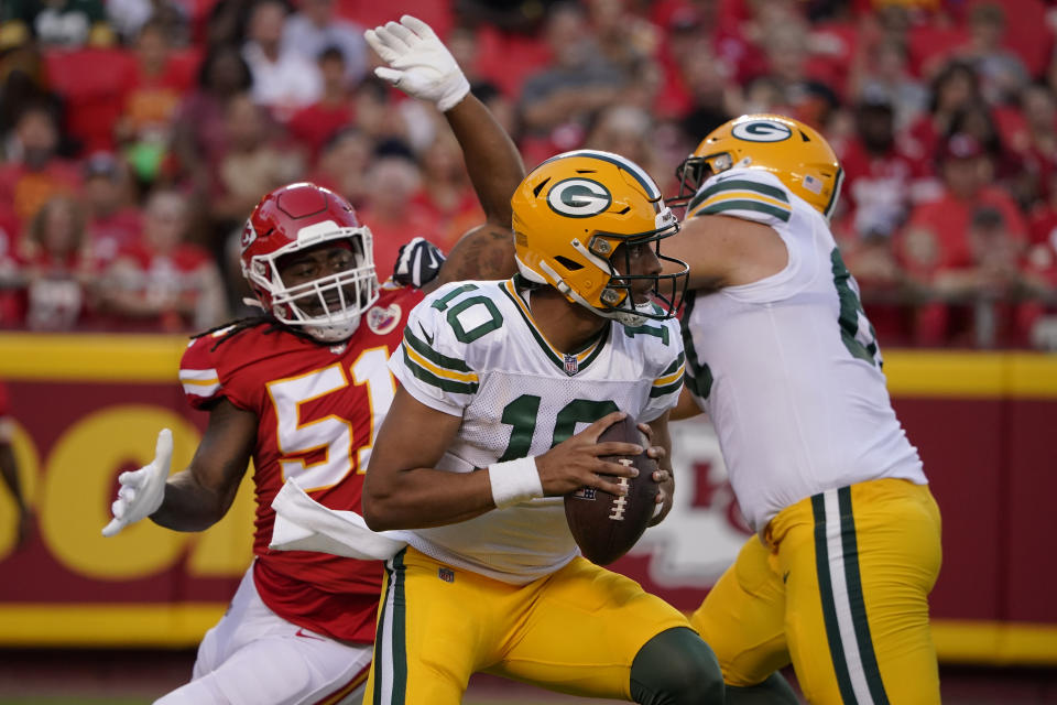Green Bay Packers quarterback Jordan Love (10) drops back to pass under pressure from Kansas City Chiefs defensive end Mike Danna (51) during the first half of an NFL preseason football game Thursday, Aug. 25, 2022, in Kansas City, Mo. (AP Photo/Ed Zurga)