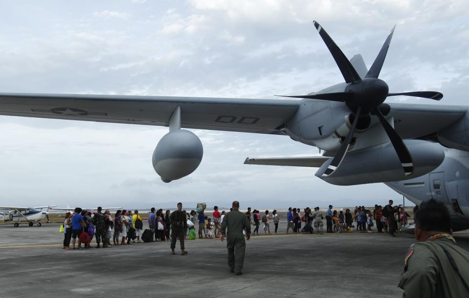 Residents prepare to board a U.S. military C130 aircraft to leave for Manila after the Super typhoon Haiyan battered Tacloban city in central Philippines