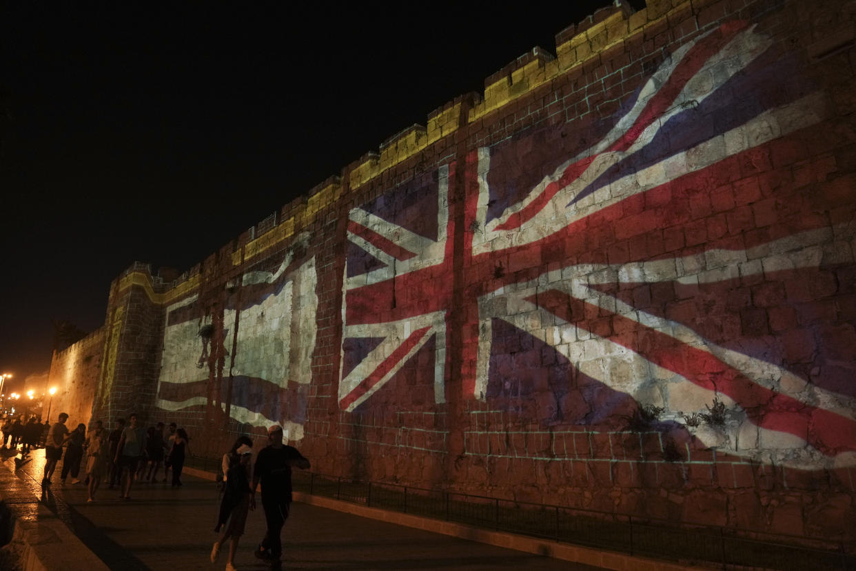 Images of the Union flag and Israeli flag are projected on the walls of Jerusalem's Old City, after the death of Queen Elizabeth II, in Jerusalem, Thursday, Sept. 8, 2022. AP Photo/Mahmoud Illean)