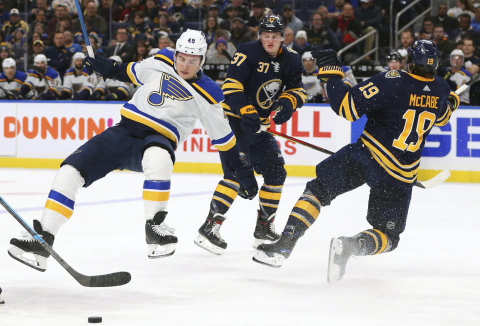 Buffalo Sabres defenseman Jake McCabe (19) and St. Louis Blues forward Ivan Barbashev (49) collide during the second period of an NHL hockey game, Tuesday, Dec. 10, 2019, in Buffalo, N.Y. (AP Photo/Jeffrey T. Barnes)