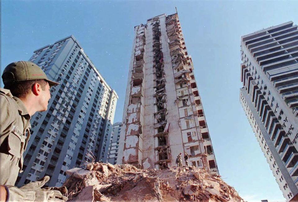 A firefighter from Rio De Janeiro, Brazil looks at the partially collapsed, 22-story Palace II before what was left of it was imploded. The apartment tower collapsed Feb. 22, 1988, killing eight people and leaving 120 families homeless.