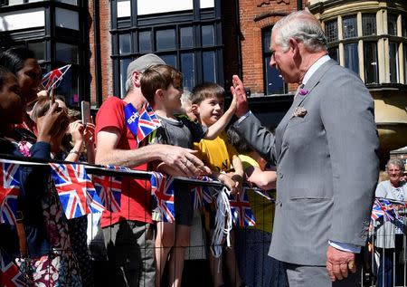 Britain's Prince Charles 'high-fives' a well-wisher during visit to Salisbury in southwest Britain, June 22, 2018. REUTERS/Toby Melville