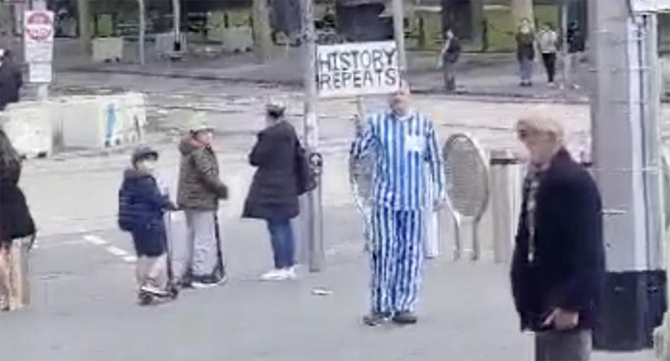 The man wore striped pyjamas holding a 'history repeats' sign. Supplied/ Anti-Defamation Commission