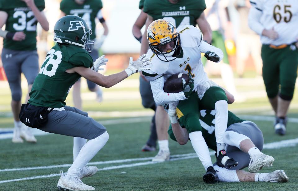 Pleasantville's Brian McPhee (13) stops Ravena's Frankie Broadhurst (1) on a first half run during the Class B football state semifinal at Middletown High School Nov. 26, 2022. .