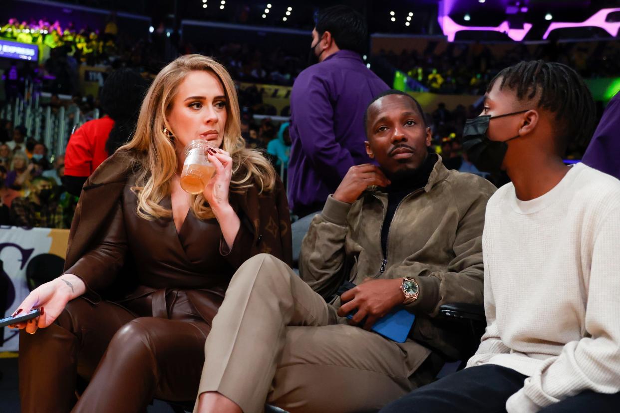 (Left) Adele and Rich Paul (center) attend an NBA basketball game between the Golden State Warriors and the Los Angeles Lakers in Los Angeles on Oct. 19, 2021.