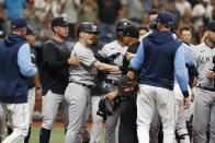 New York Yankees' Josh Donaldson, fourth from left, talks with home plate umpire umpire Vic Carapazza during the second inning of a baseball game against the Tampa Bay Rays, Sunday, Sept. 4, 2022, in St. Petersburg, Fla. (AP Photo/Scott Audette)
