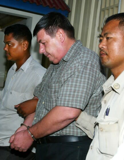 A U.S. citizen Michael Joseph Pepe, 52, is escorted by police out of the Phnom Penh Municipal Court in Phnom Penh, Cambodia, Monday, June 19, 2006. Cambodian prosecutor on Tuesday charged him with having sex with young girls in Cambodia's latest crackdown on foreign sexual predators in the impoverished Southeast Asian country. (AP Photo/Heng Sinith)