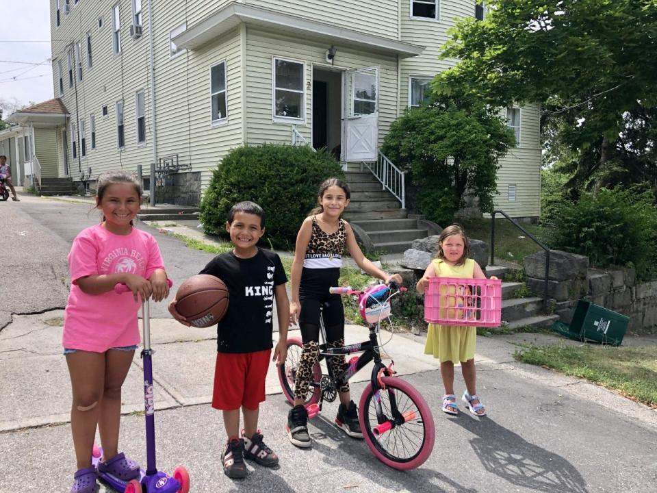 Kids play outside in a Worcester neighborhood on the first day with slightly cooler temperatures after last week's intense heat.