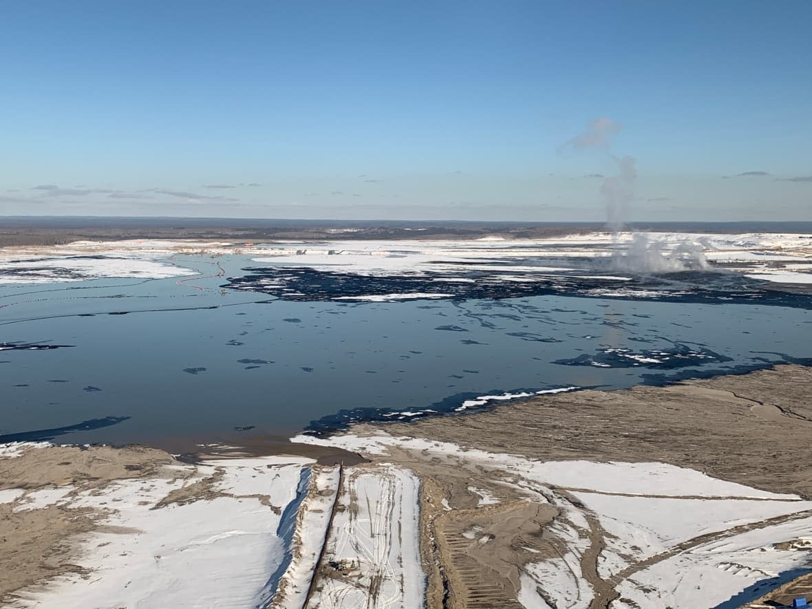 A view from a helicopter of the tailings ponds at the Kearl Lake oilsands project in northern Alberta. Residents of Fort Chipewyan, which is downstream from the ponds, say they only learned there had been seepage from the ponds in February — nine months after it was first discovered.  (Julia Wong/CBC - image credit)