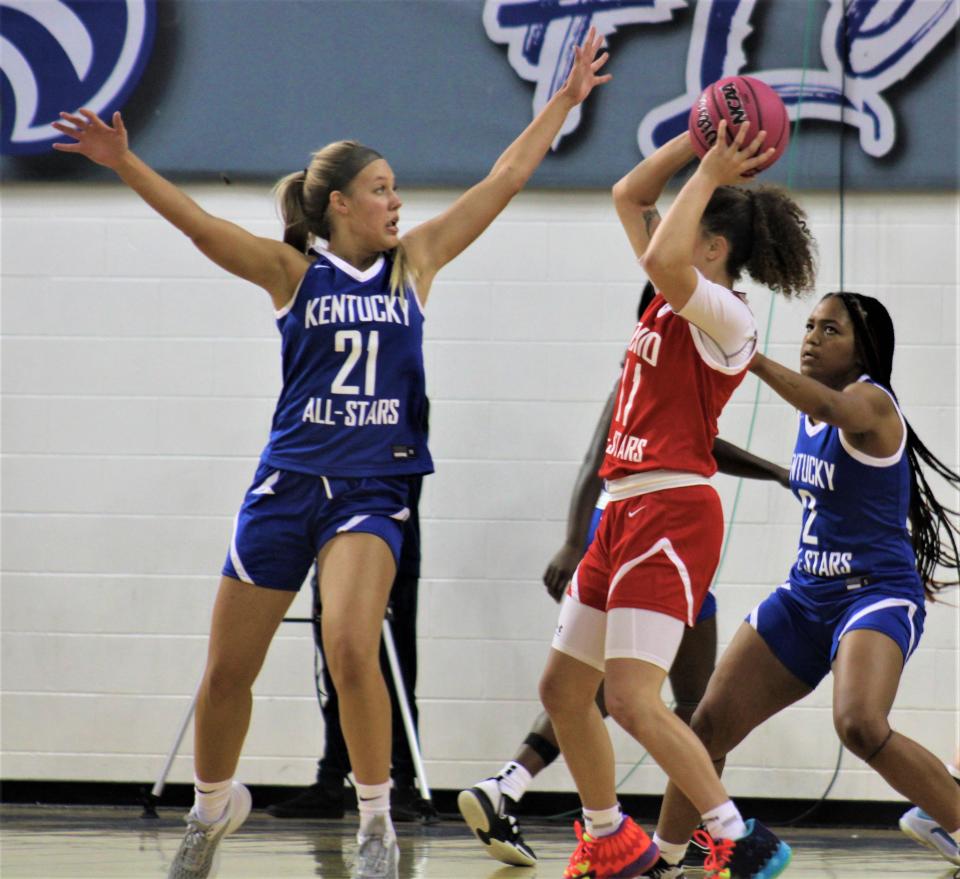 Grace Brewer of Walton-Verona (21) tries to disrupt the shot of Taylor Farris of Talawanda as Kentucky defeated Ohio 117-94 in the girls edition of the Ohio-Kentucky All-Star Game April 8, 2023, at Thomas More University's Connor Convocation Center.