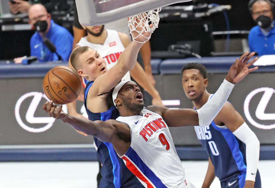 Detroit Pistons forward Jerami Grant (9) shoots as Dallas Mavericks center Kristaps Porzingis (6) defends during the third quarter at American Airlines Center in Dallas on Wednesday, April 21, 2021.