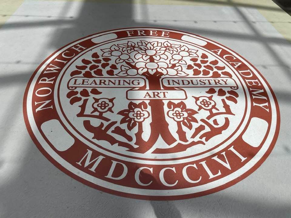 The Norwich Free Academy seal on the school floor.