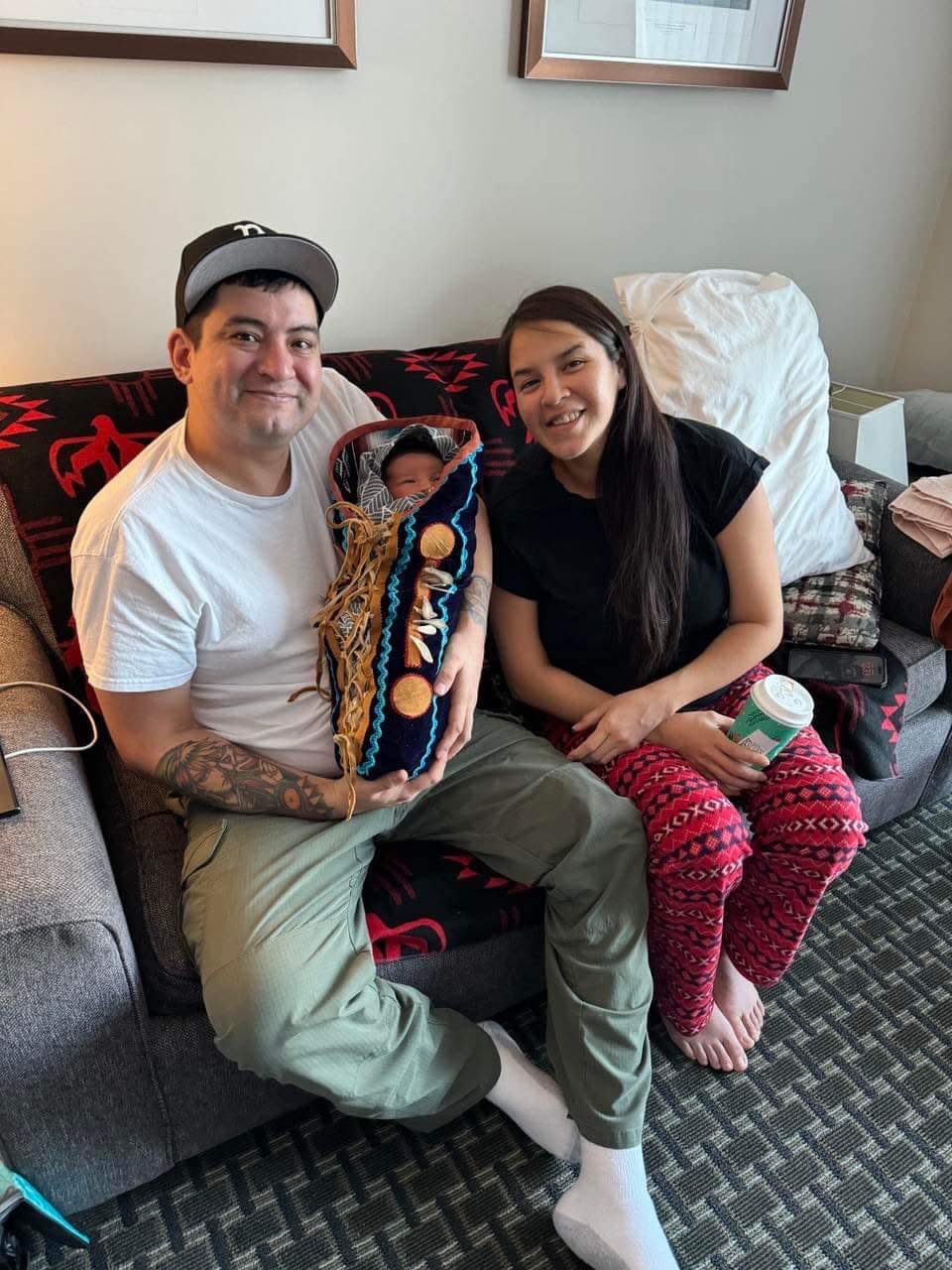 Shonto Noeldeke-Catholique (left) and Kristen Kodakin-Yakeleya (right) had their first child, Shëth La (centre), in Yellowknife on Jan. 3, 2024. Their baby boy won a prize for being the first child born in the territory in 2024.