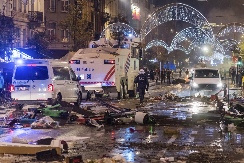 Police cars drive through a main boulevard in Brussels, Sunday, Nov. 27, 2022, as violence broke out during and after Morocco's 2-0 win over Belgium at the World Cup. (AP Photo/Geert Vanden Wijngaert)