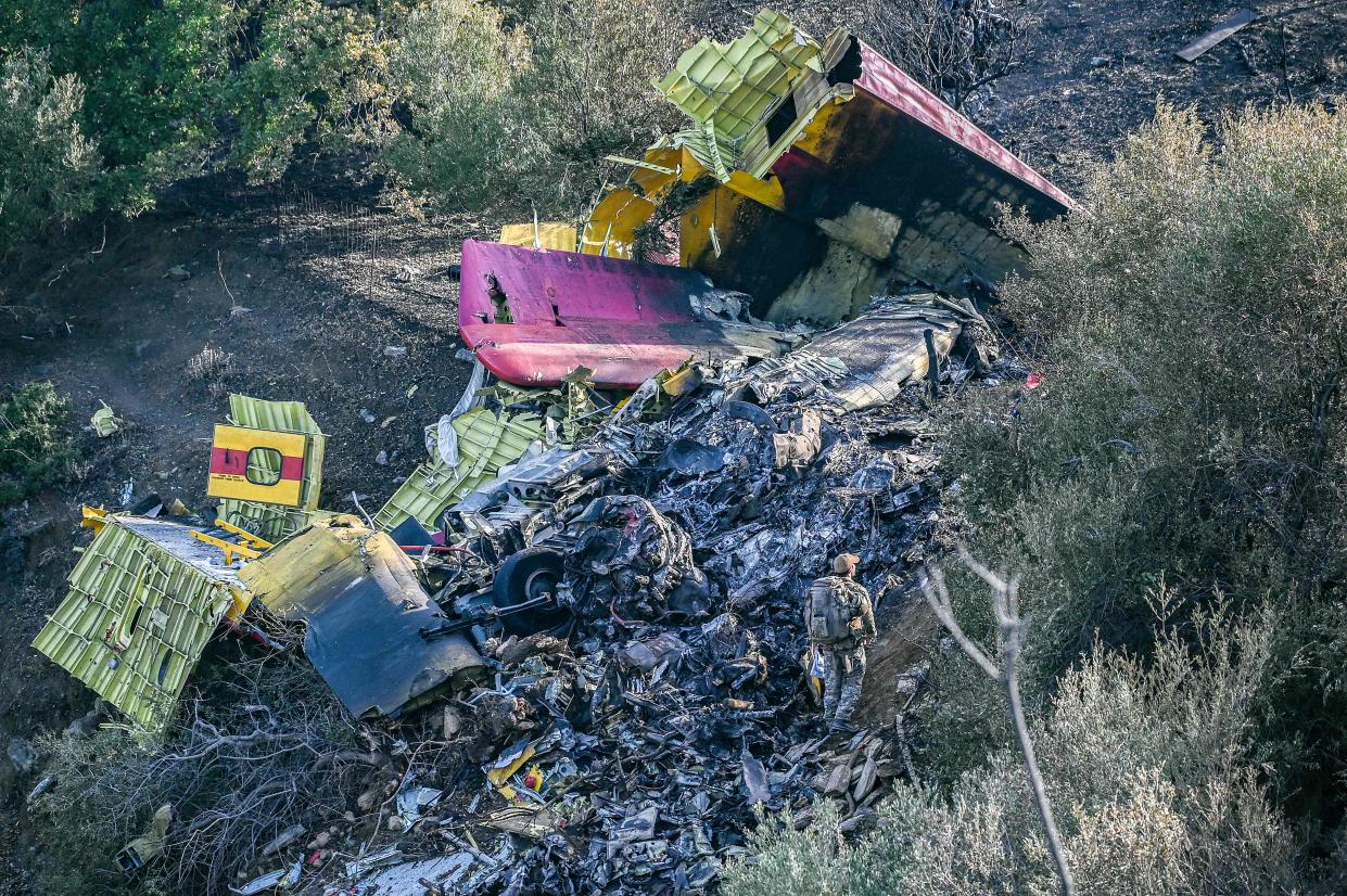 Debris of a Canadair CL-215 firefighting aircraft, which crashed near while being flown to fight a wildfire in Karystos, on the Greek Aegean island of Evia, on July 25, 2023. Two pilots died when their water-bombing plane crashed while battling a blaze on the Greek island of Evia (AFP/Getty)