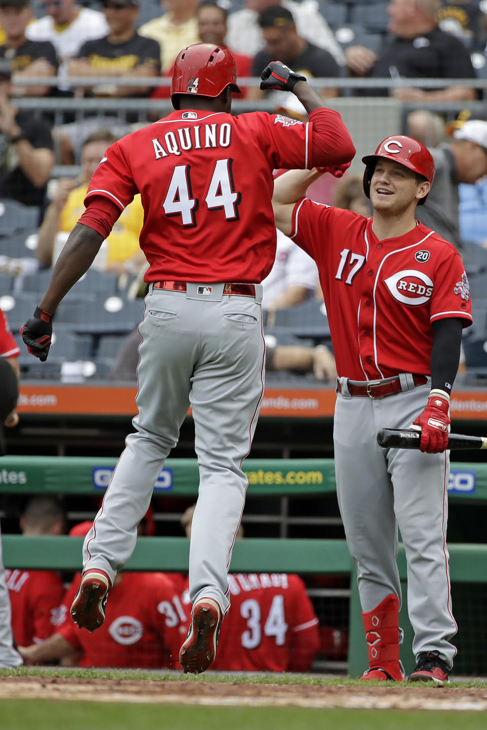 Cincinnati Reds' Aristides Aquino (44) celebrates with Josh VanMeter after hitting a solo home run off Pittsburgh Pirates starting pitcher Trevor Williams during the second inning of a baseball game in Pittsburgh, Sunday, Sept. 29, 2019. (AP Photo/Gene J. Puskar)