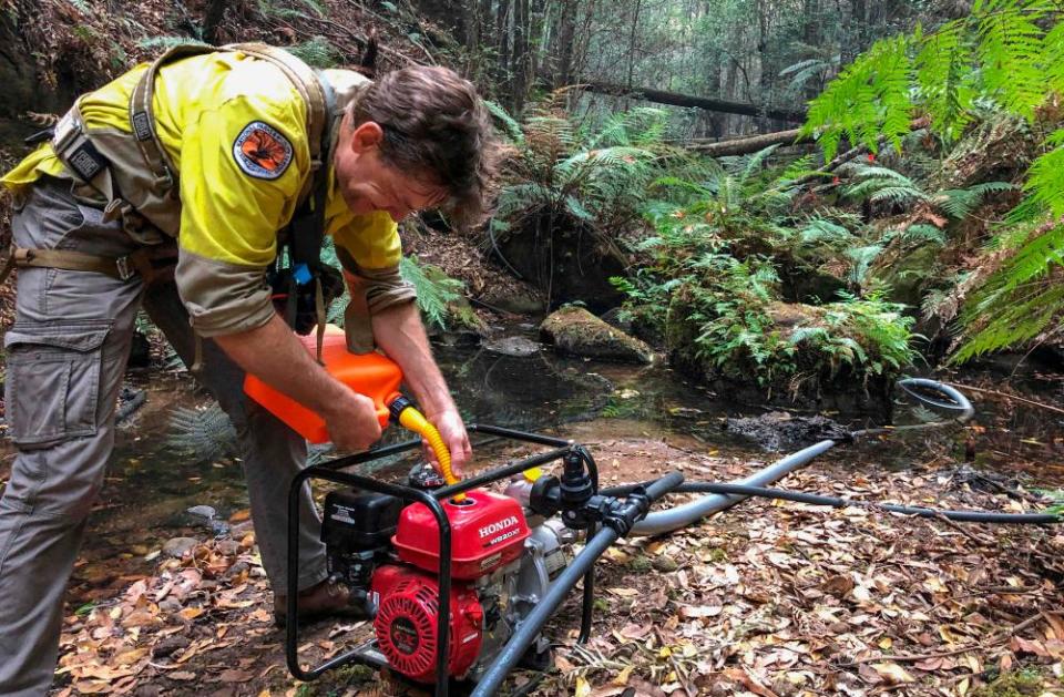 Firefighter operating irrigation machine