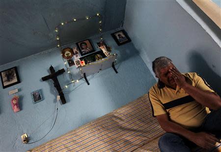 Pedro Payan sits underneath a shrine dedicated to his late daughter Dulce Cristina at their home in Ecatepec April 30, 2013. REUTERS/Henry Romero