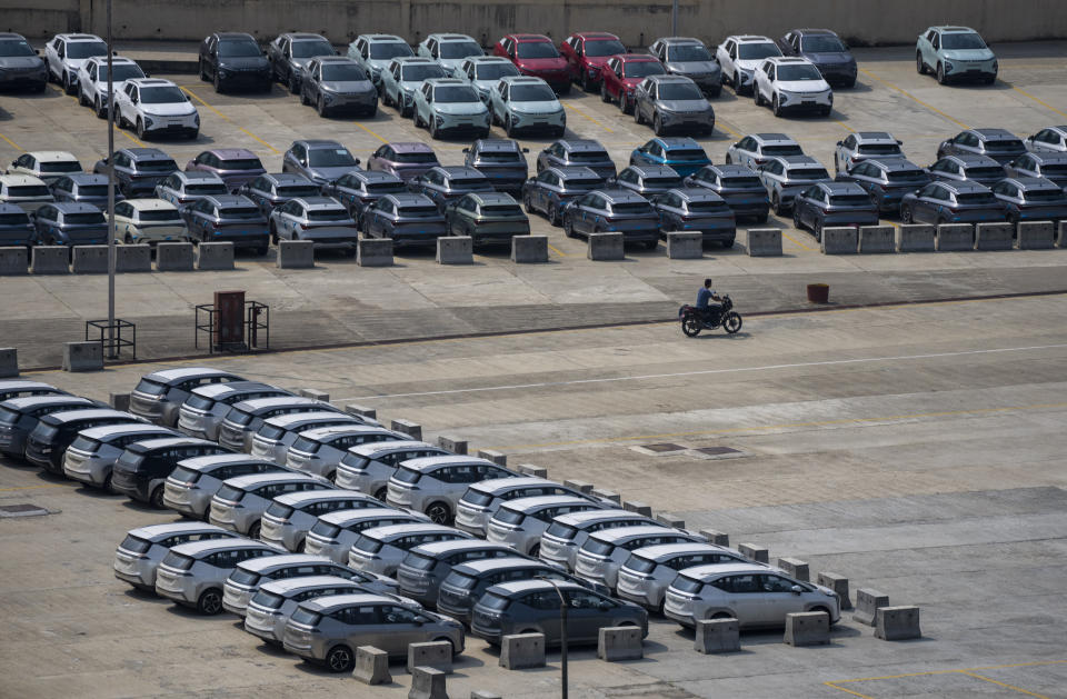 Newly imported electric vehicles are seen parked at the Chobhar Dry Port in Kirtipur, Nepal, Friday, May 31, 2024. To encourage purchases of EVs, the government is charging lower duties on imported EVs, ranging from 25% to 90%. The import duties on gas and diesel-fueled vehicles are 276% to 329%. (AP Photo/Niranjan Shrestha)