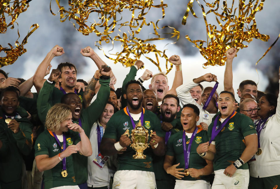 In this Saturday, Nov. 2, 2019, file photo, South African captain Siya Kolisi holds the Webb Ellis Cup aloft after South Africa defeated England to win the Rugby World Cup final at International Yokohama Stadium in Yokohama, Japan. (AP Photo/Christophe Ena, File)