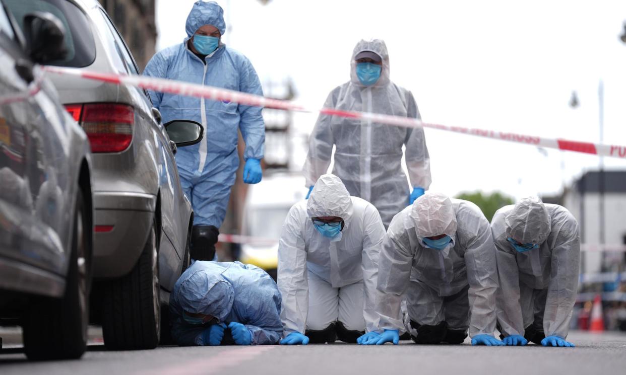 <span>Police forensic officers in Dalston, east London, near to the scene of the 29 May shooting.</span><span>Photograph: James Manning/PA</span>