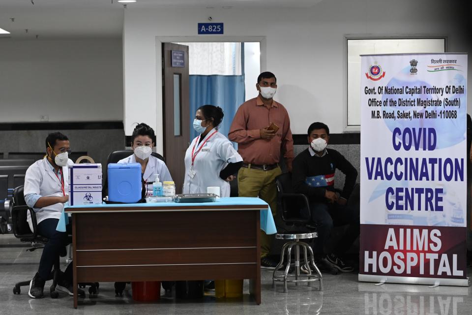 Health workers wait for the start of the Covid-19 coronavirus vaccination drive at the All India Institute of Medical Science (AIIMS) in New Delhi in January 16, 2021. (Photo by Sajjad HUSSAIN / AFP) (Photo by SAJJAD HUSSAIN/AFP via Getty Images)