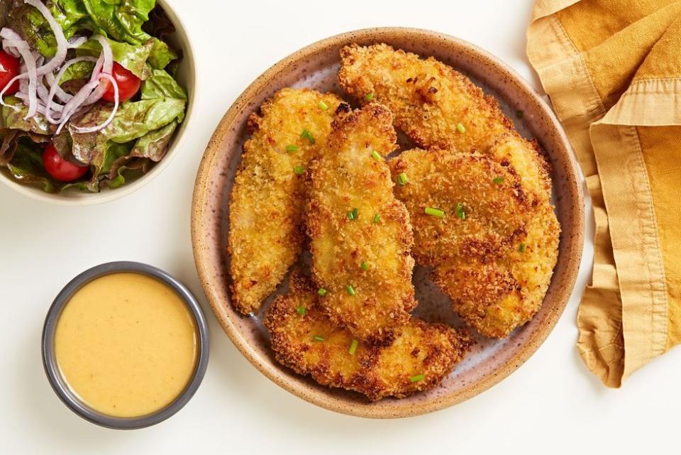 <p>Crispy chicken tenders without the deep fryer? YES! These <a href="https://www.delish.com/uk/kitchen-accessories/g31784513/best-air-fryer/" rel="nofollow noopener" target="_blank" data-ylk="slk:air fryer;elm:context_link;itc:0;sec:content-canvas" class="link ">air fryer</a> chicken tenders only need 10 minutes to get golden and crispy. The honey mustard dipping sauce can be stirred together during that time to make this a fast and weeknight friendly meal.</p><p>Get the <a href="https://www.delish.com/uk/cooking/recipes/a33939752/air-fryer-chicken-tenders-recipe/" rel="nofollow noopener" target="_blank" data-ylk="slk:Air Fryer Chicken Tenders;elm:context_link;itc:0;sec:content-canvas" class="link ">Air Fryer Chicken Tenders</a> recipe.</p>