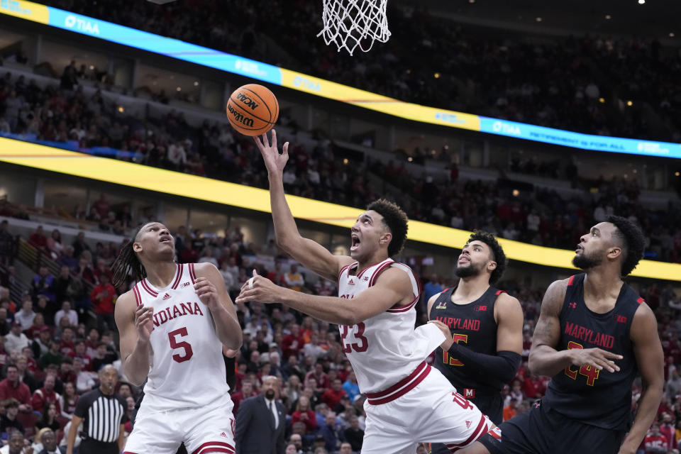 FILE - Indiana's Trayce Jackson-Davis (23) scores past Maryland's Patrick Emilien (15) and Donta Scott as Malik Reneau watches during the second half of an NCAA college basketball game at the Big Ten men's tournament, Friday, March 10, 2023, in Chicago. Indiana won 70-60. Jackson-Davis was selected to the Associated Press All-America first team in results released Tuesday, March 14, 2023. (AP Photo/Charles Rex Arbogast, File)