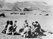 FILE - In this Oct. 30, 1951, file photo, Chinese army men prepare food with Tibetan cowherds in Tibet. (AP Photo, File)