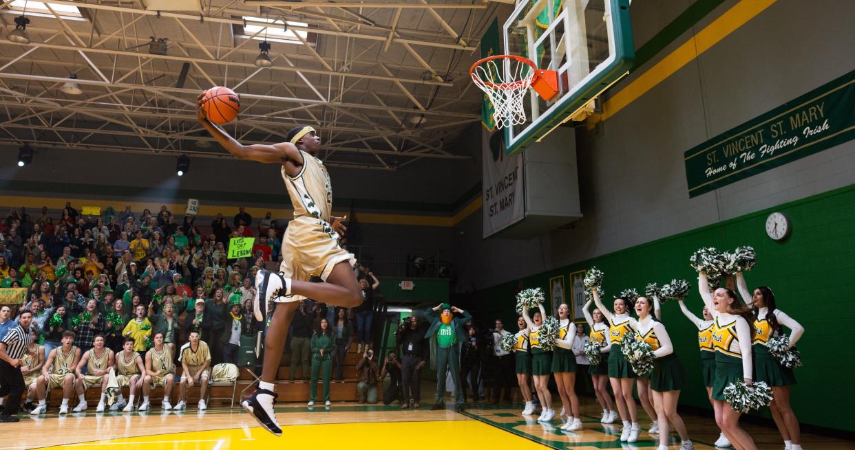 LeBron James (Marquis “Mookie” Cook) flies in for a dunk in the sports biopic 