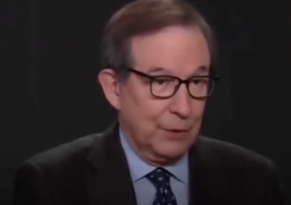 Chris Wallace, wearing a suit and tie, is speaking during an interview