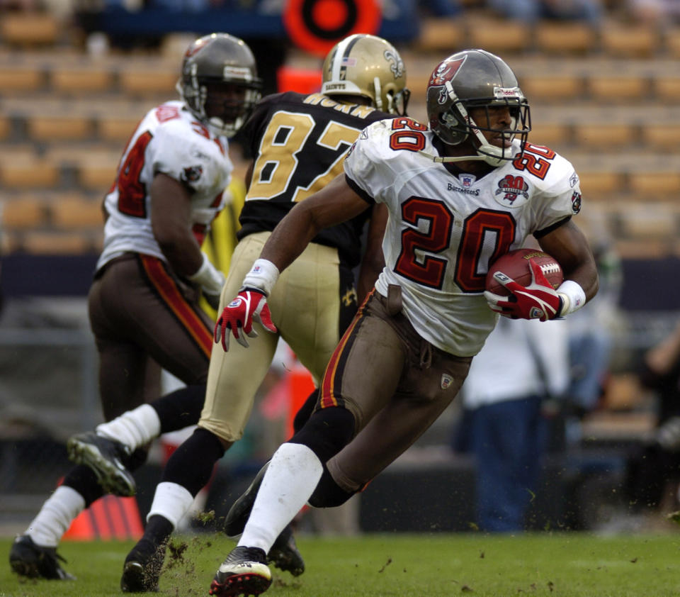 FILE - Tampa Bay Buccaneers cornerback Ronde Barber runs the ball after making an interception in the closing minutes of an NFL football game against New Orleans Saints on Dec. 4, 2005, in Baton Rouge, La. Barber never doubted he’d wind up in the Pro Football Hall of Fame. The undersized cornerback’s journey included some of the most memorable plays in Tampa Bay Buccaneers history, as well as five trips to Canton in which he resisted the temptation to step foot in the building where he’ll be enshrined as part of a class of nine 2023 inductees. (AP Photo/Paul Rutherford, File)