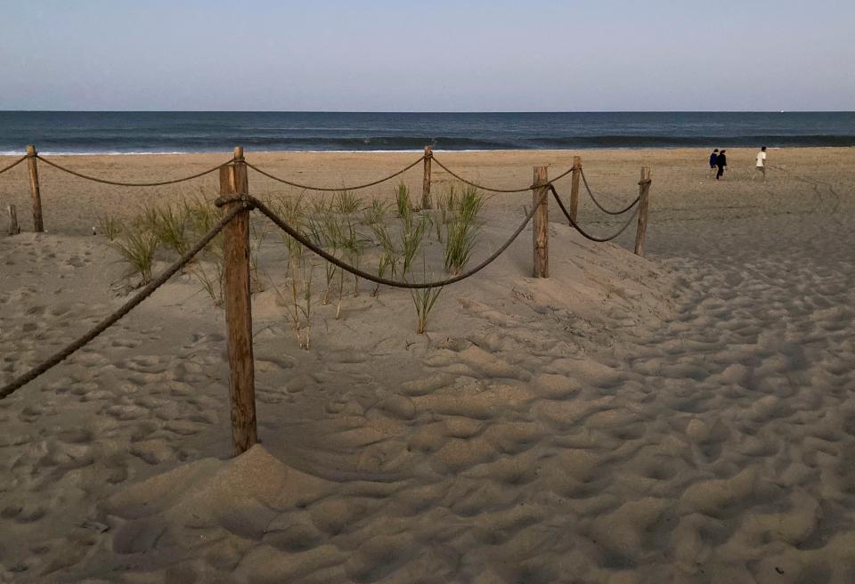 People stroll the nearly deserted beach at Fenwick Island State Park after sunset, Saturday, Sept. 2, 2023 during the unofficial end to summer, Labor Day Weekend.