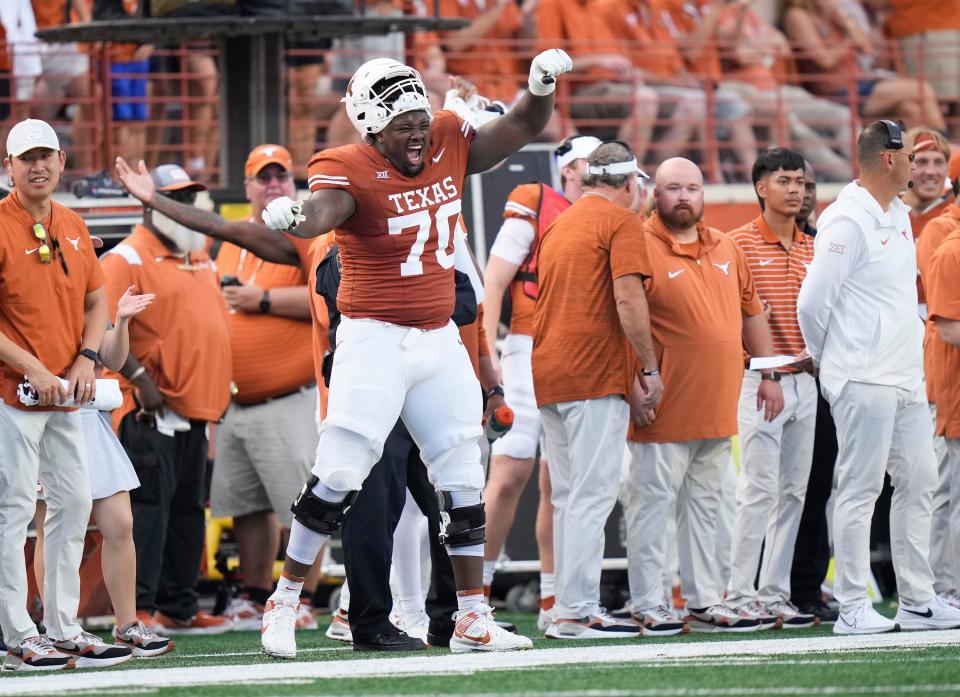 Christian Jones celebrates on the sideline during the fourth quarter of the Longhorns' win over BYU on Oct. 28. Jones is hoping his name will be called during this year's NFL draft.